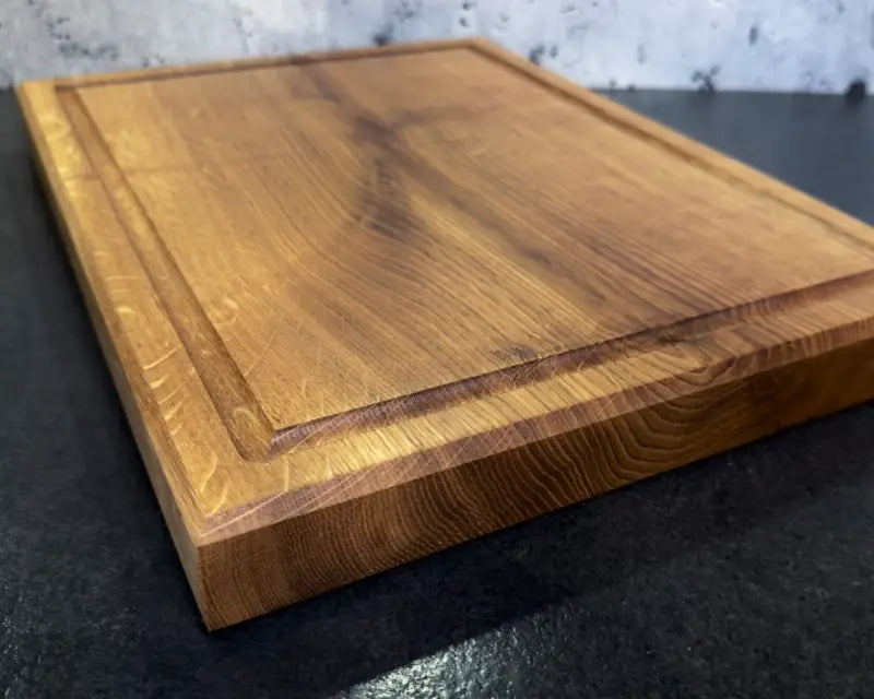 Nahaufnahme: Küchenbrett aus massiver Eiche mit Saftrille, Detail der stabilen 4 cm starken Holzplanke.