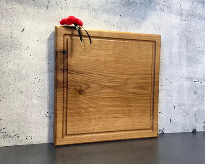 Massives Eichenholzbrett 30x30 cm – in sanfter Schrägsicht, zeigt Stärke & Form vor hellem, modernem Hintergrund