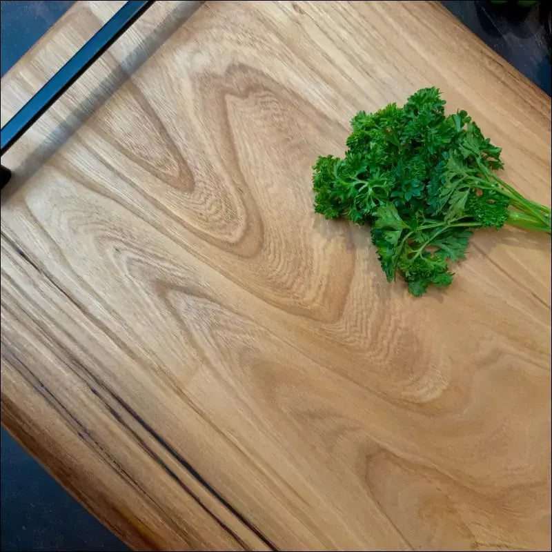 Fresh parsley on a handcrafted elm wood cutting board.