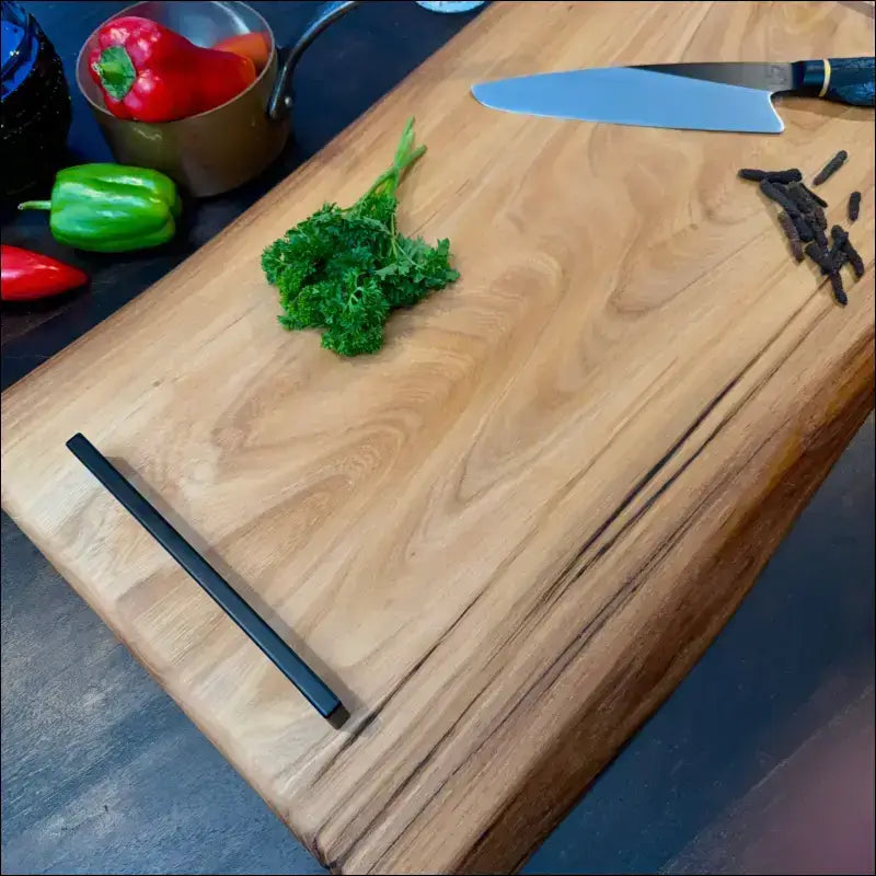 Handcrafted elm wood cutting board with dark inlay on the bottom edge.