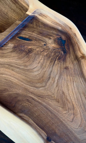 Solid wood serving board with great grain and blue epoxy resin in the extraordinary design.